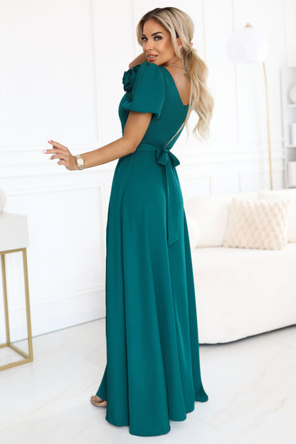 653-1 Elegant long dress with a rose, belt and high slit - bottle green
